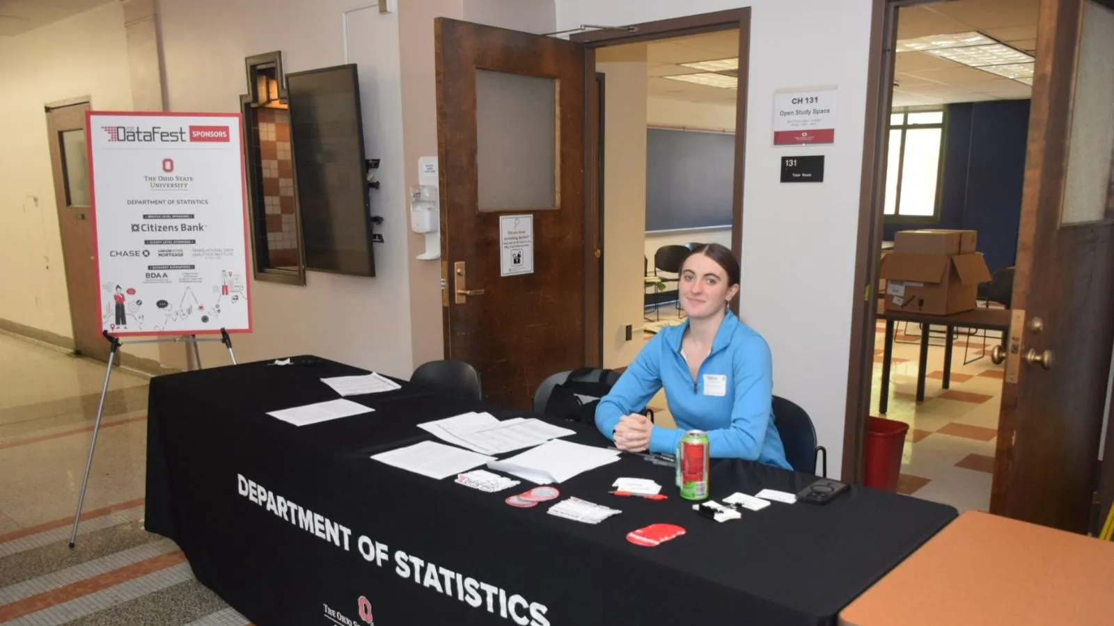 Student sitting at DataFest registration desk.