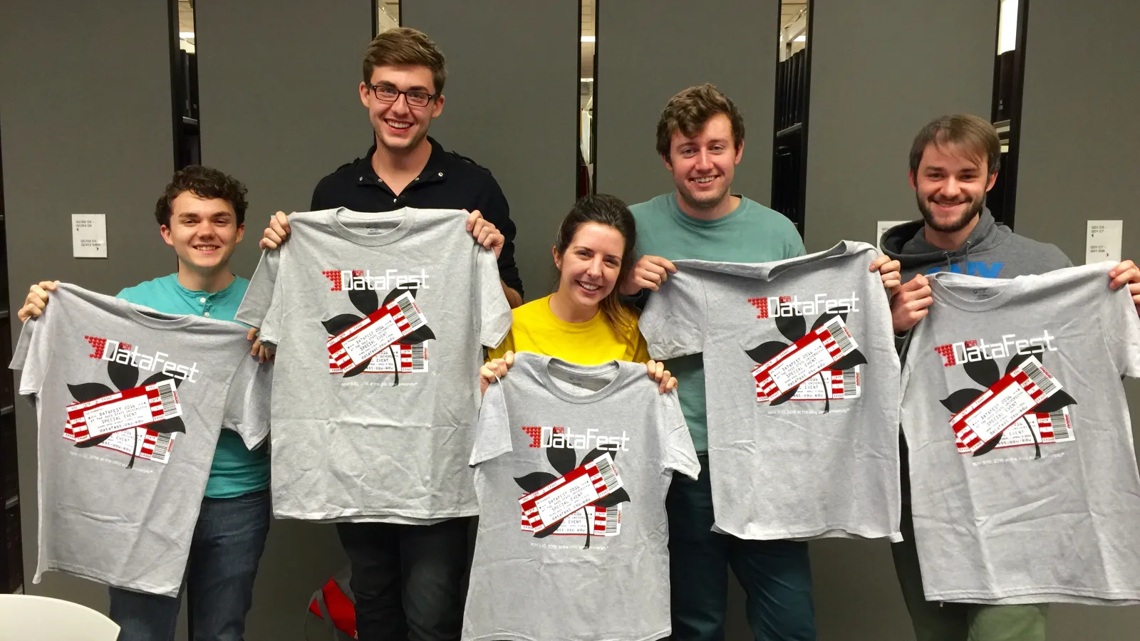 Students holding their Data Fest 2016 t-shirts