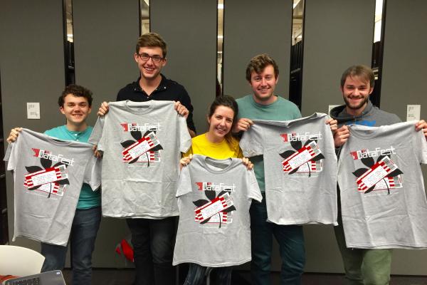 DataFest 2016 Students holding their Data Fest 2016 t-shirts
