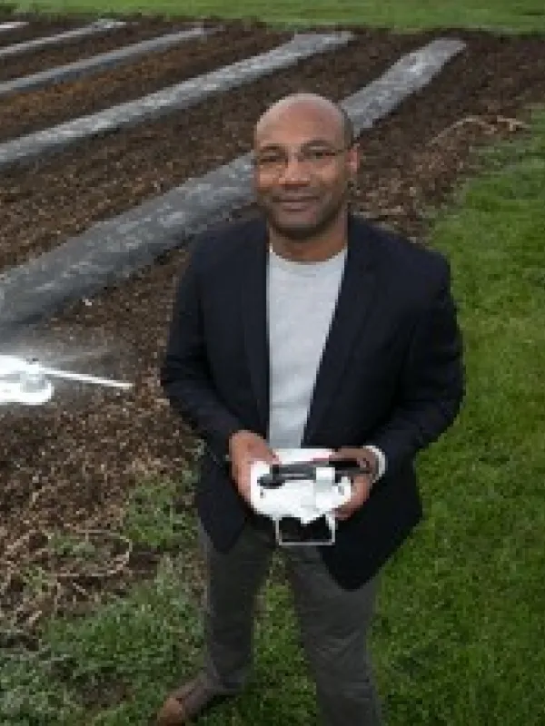 Chris Stewart operating a small drone out in a field